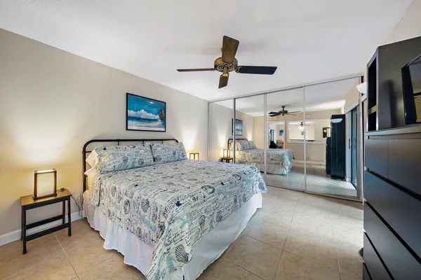 a spacious bedroom with a large bed and a dresser
