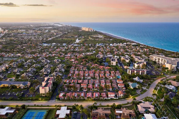 an aerial view of residential building and ocean