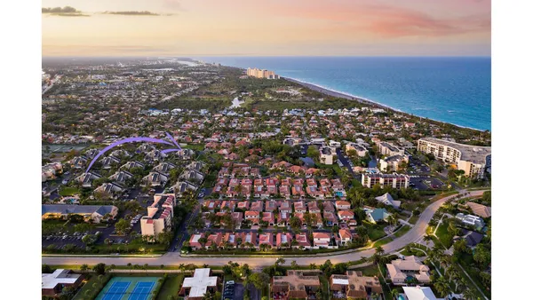an aerial view of residential building and ocean