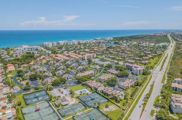 an aerial view of residential houses with outdoor space and river