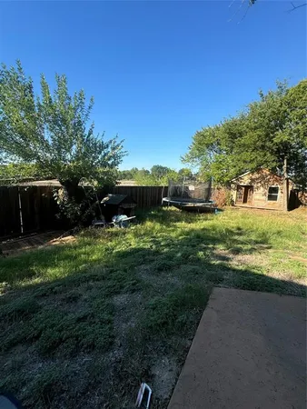 a view of a garden with a building in the background