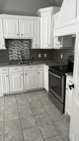 a kitchen with cabinets and appliances