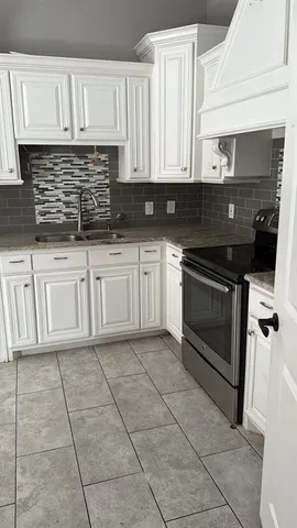 a kitchen with cabinets and appliances