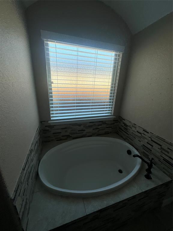 2321 3rd Street Sachse, TX 75048 - Photo 8 of 8 a bath tub sitting in a bathroom next to a window