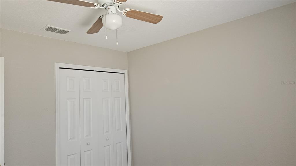 108 Brittany Road Mascotte, FL 34753 - Photo 11 of 17 an empty room with closet and a chandelier fan