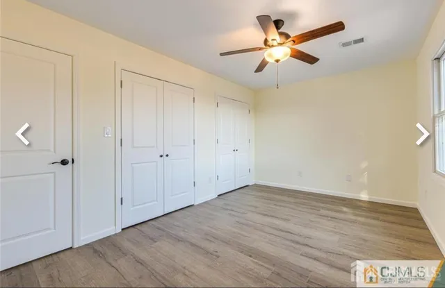 an empty room with fan and a ceiling fan