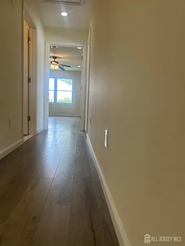 a view of hallway with wooden floor