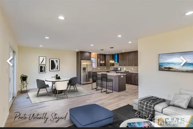 a living room with furniture and kitchen view