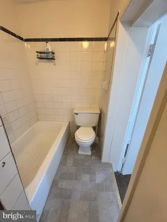 a bathroom with a bathtub and toilet