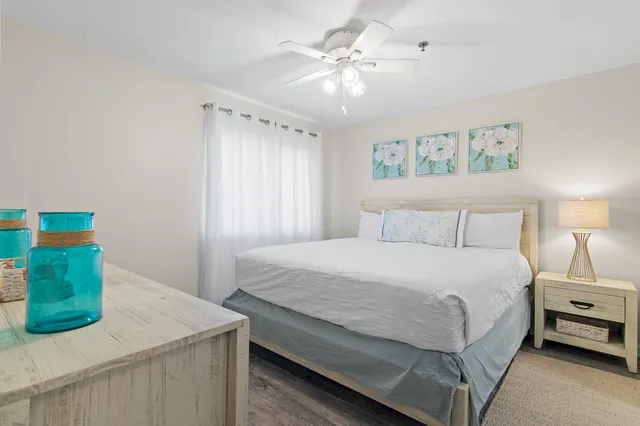 a bedroom with a bed and a painting on the wall