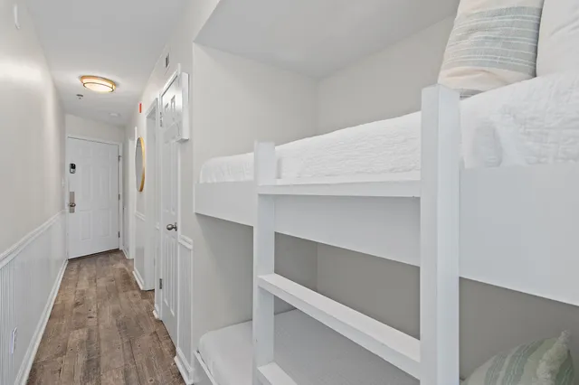 a view of a hallway with wooden floor and entryway