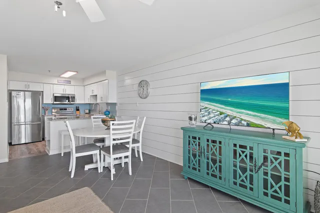 a dinning table and chairs in a open kitchen