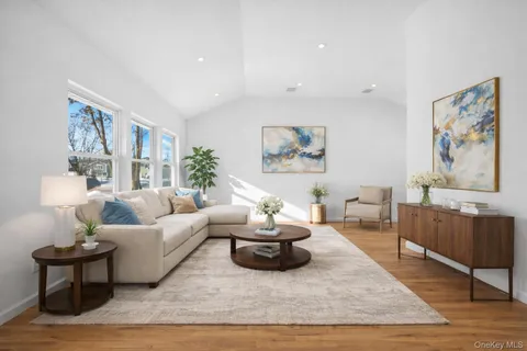 a living room with furniture and a painting on the wall