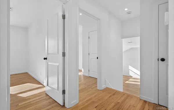 a view of a room with wooden floor and white walls