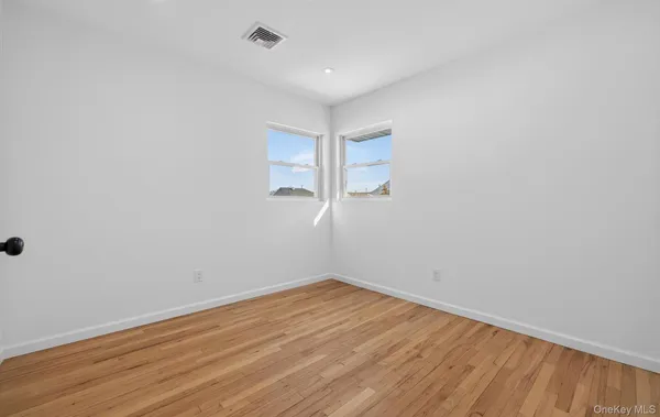 a bedroom with a bed and a potted plant