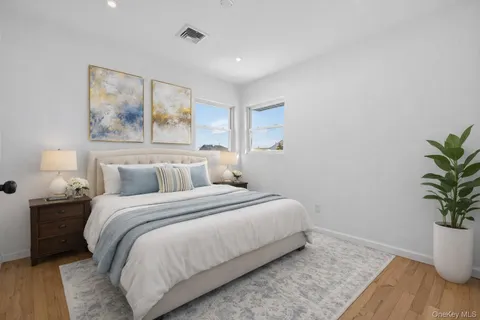 a bedroom with a bed and a potted plant