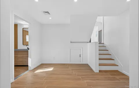 a view of entryway and hall with wooden floor