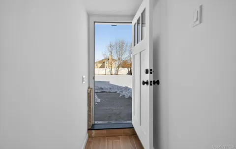a view of a hallway with wooden floor