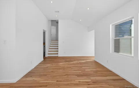 a view of a room with wooden floor and window
