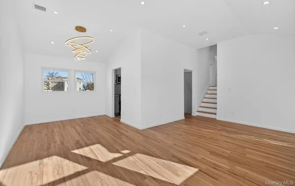 a living room with furniture and a dining table