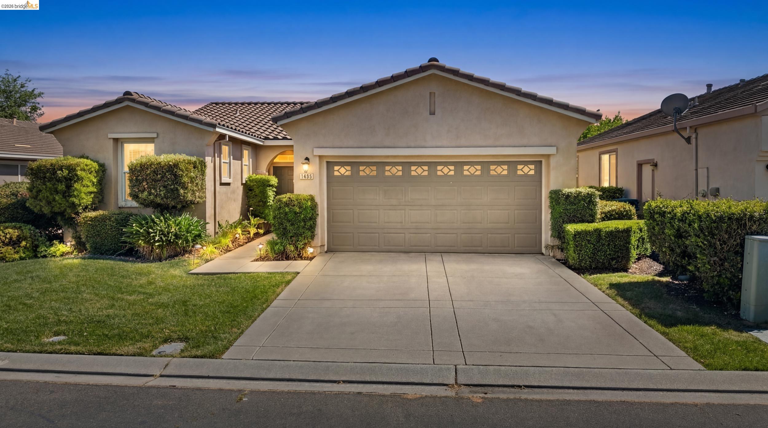a front view of a house with a yard and garage
