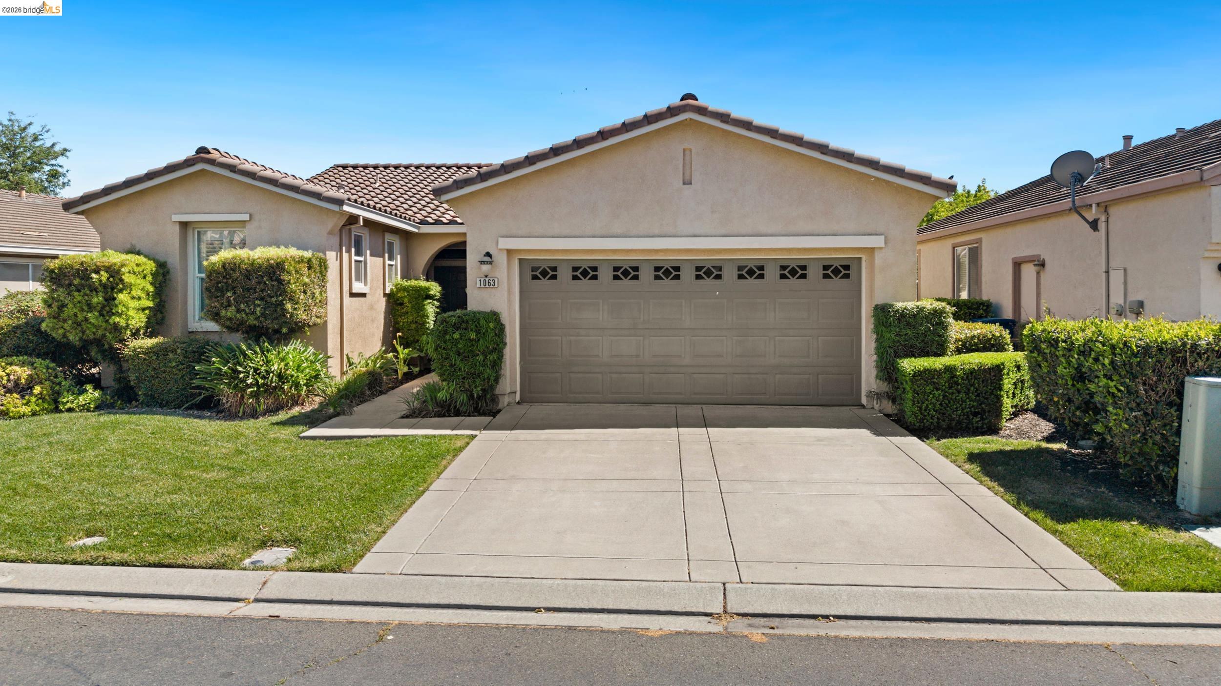 1063 Waterwood Drive Rio Vista, CA 94571 - Photo 2 of 38 a front view of a house with a yard and garage