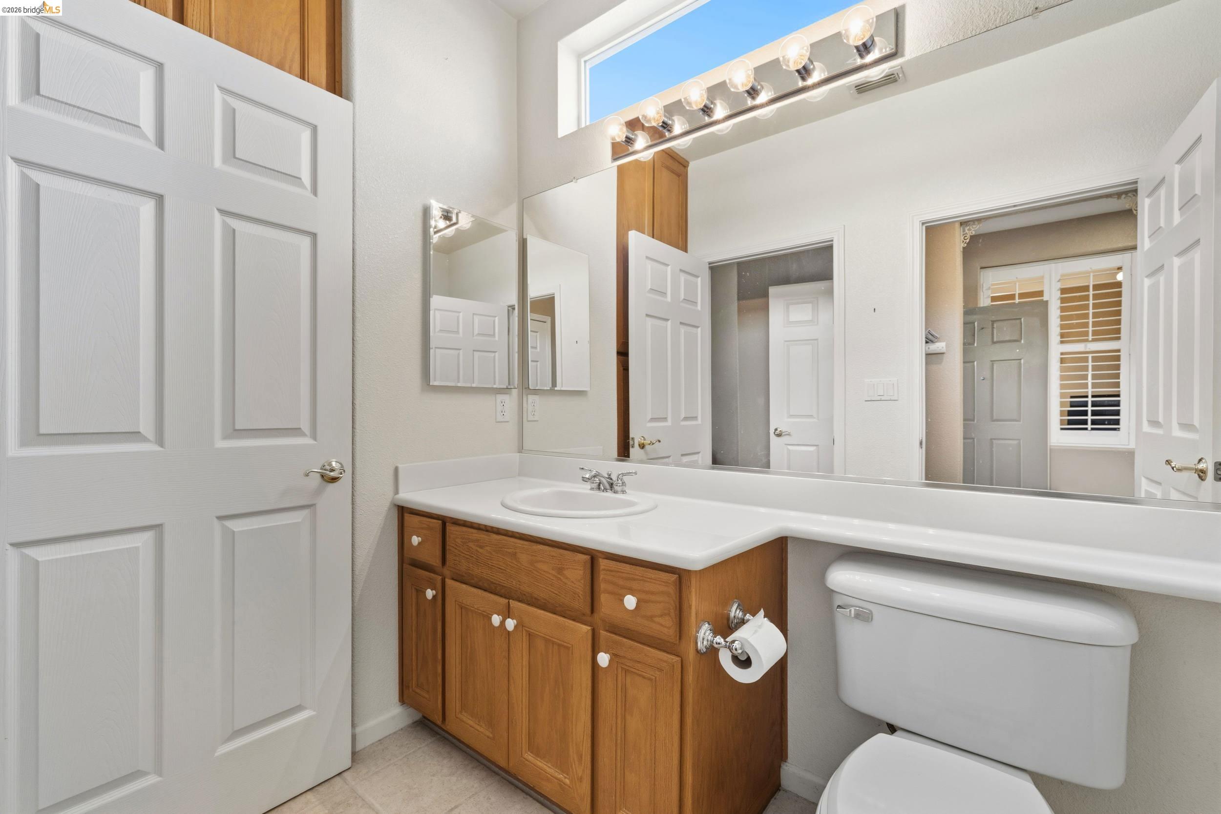 1063 Waterwood Drive Rio Vista, CA 94571 - Photo 26 of 38 a bathroom with a toilet sink and mirror