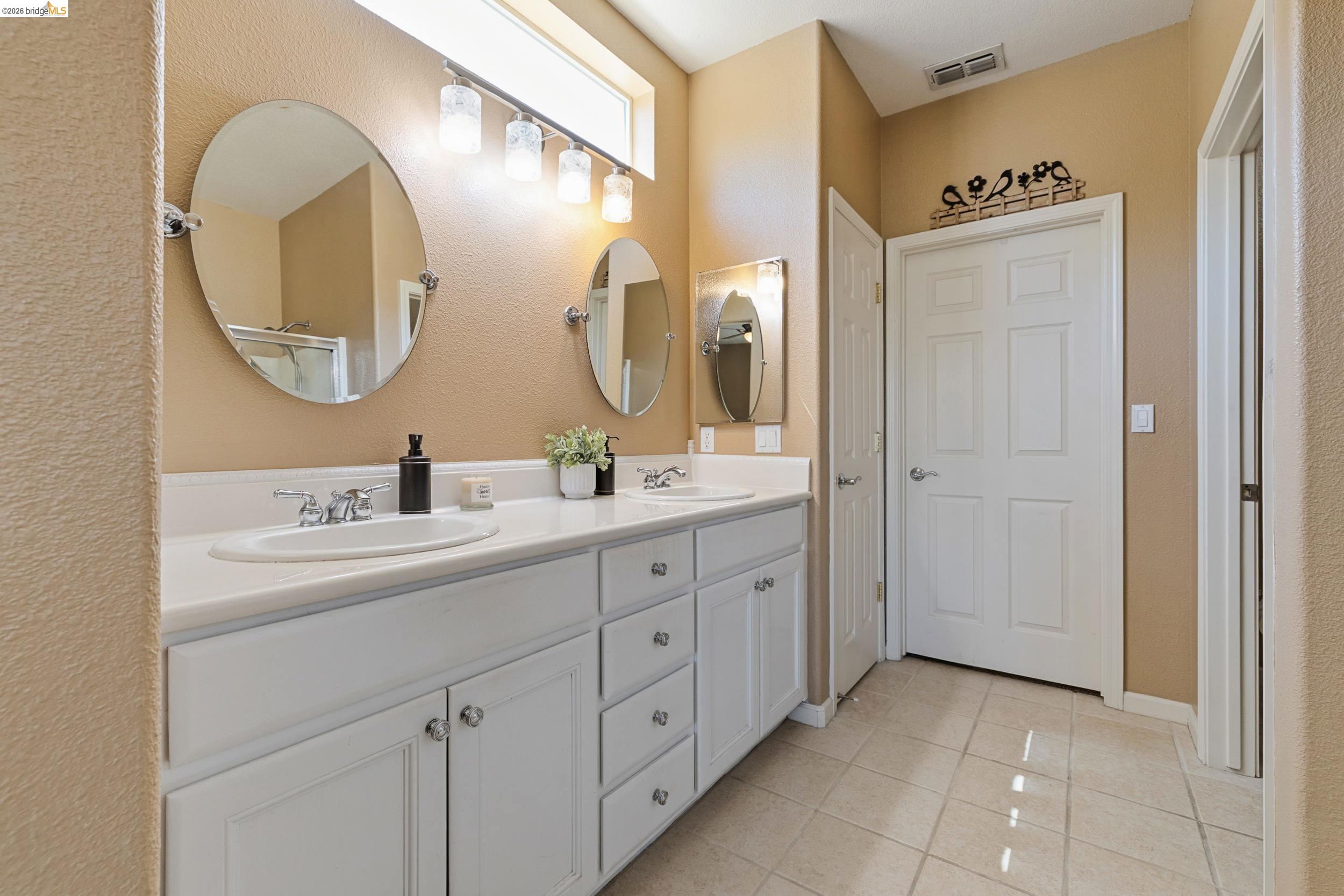 1063 Waterwood Drive Rio Vista, CA 94571 - Photo 27 of 38 a bathroom with a double vanity sink and a mirror