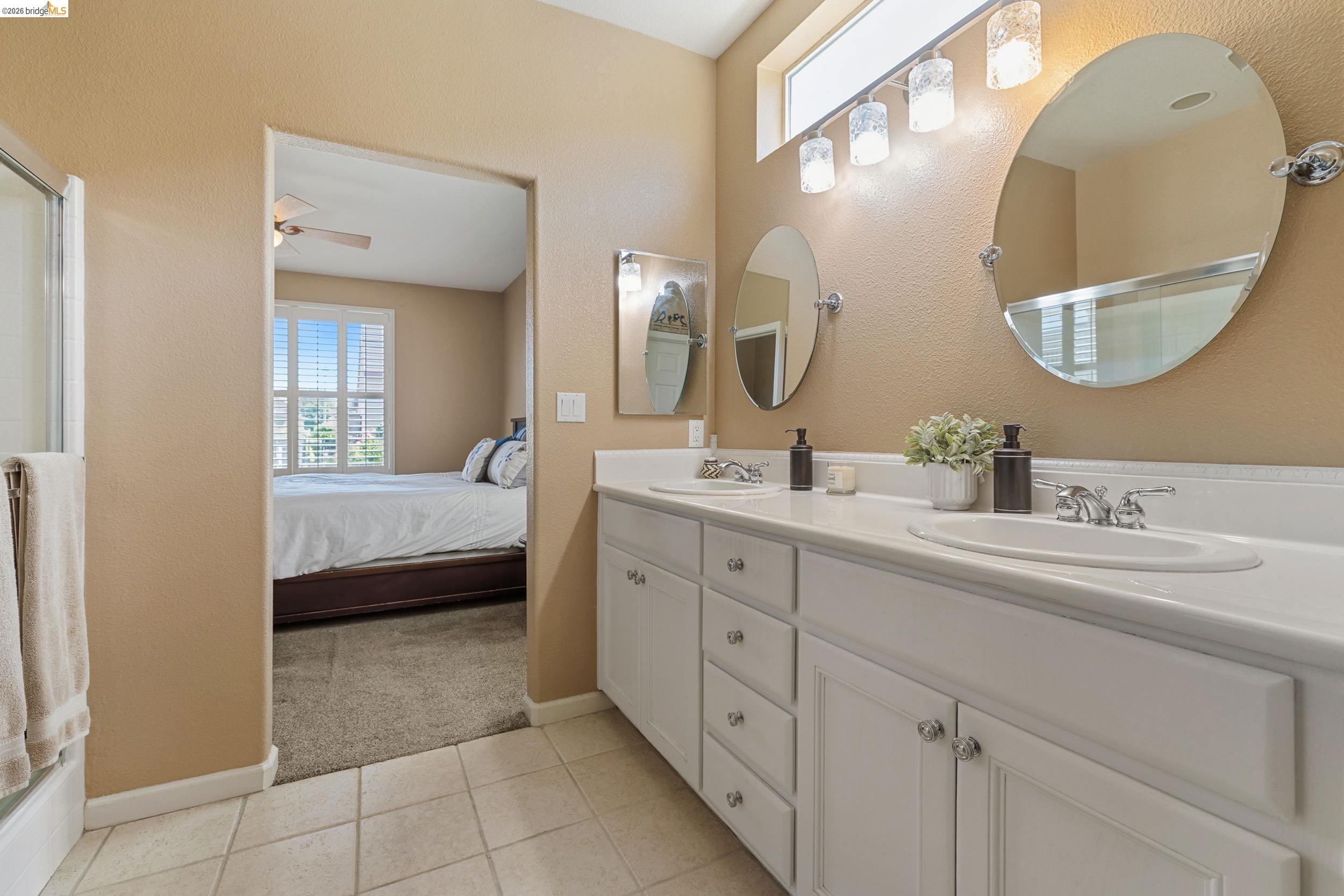 1063 Waterwood Drive Rio Vista, CA 94571 - Photo 28 of 38 a en suite bathroom with a double vanity sink and a mirror