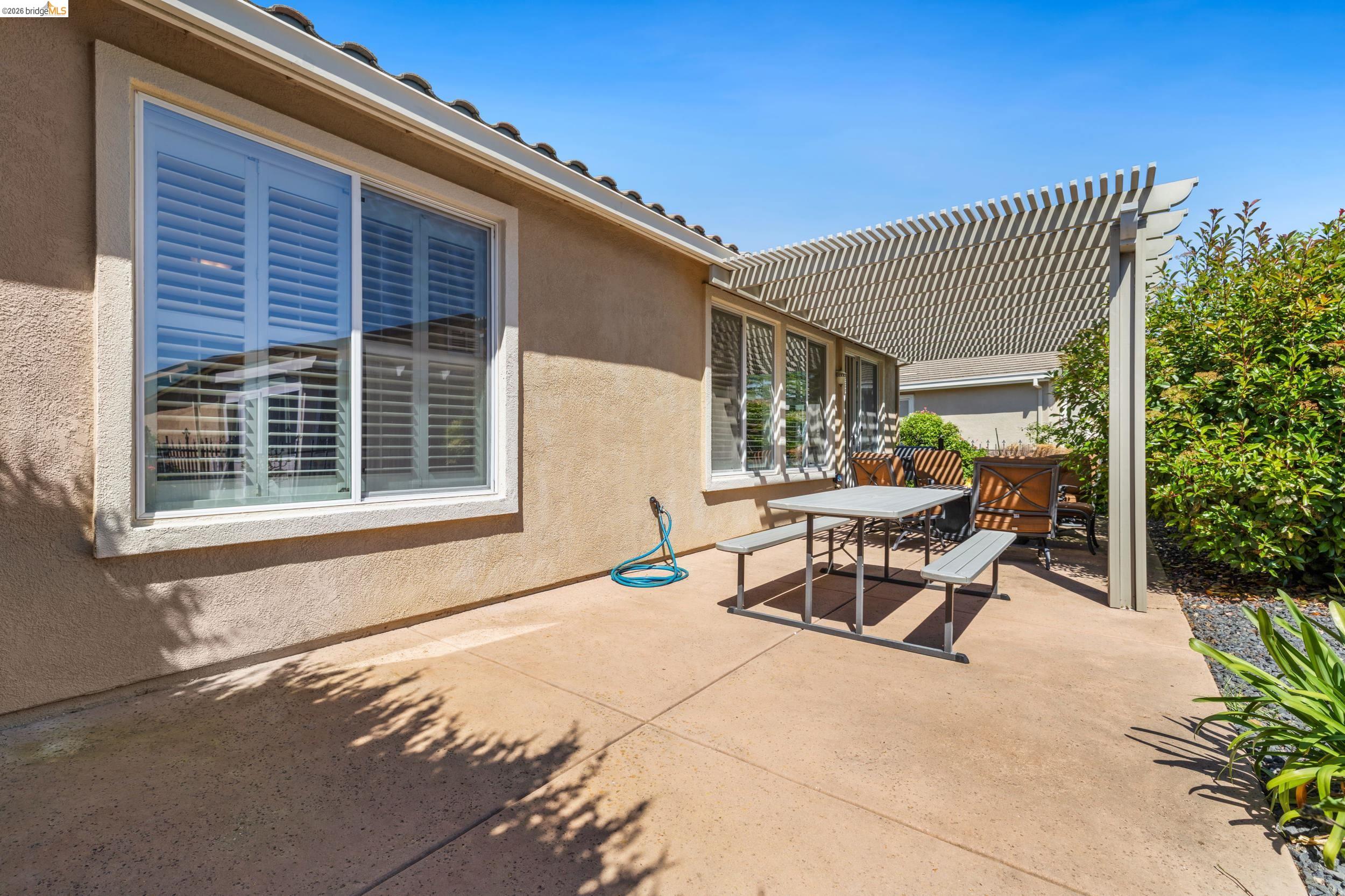 1063 Waterwood Drive Rio Vista, CA 94571 - Photo 32 of 38 a backyard of a house with a bench and some potted plants
