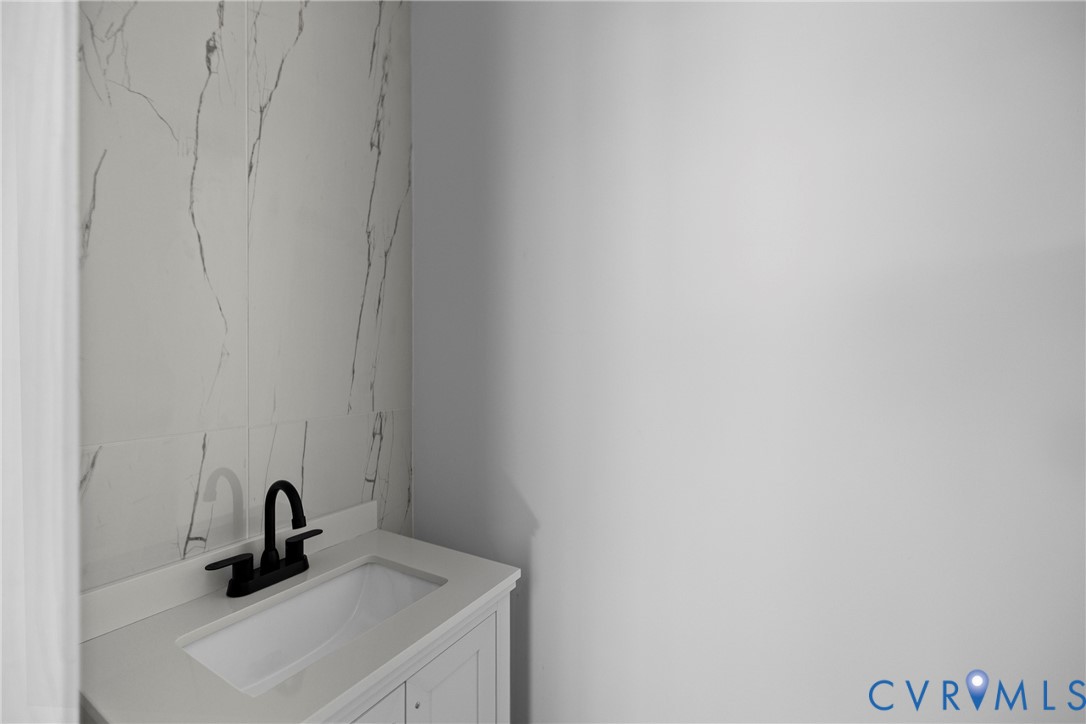 821 Fort Lee Road Petersburg, VA 23803 - Photo 17 of 45 White vanity with an integrated sink, matte black