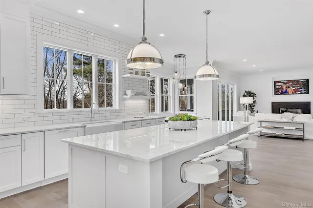 a kitchen with stainless steel appliances granite countertop a sink a stove and a wooden floors