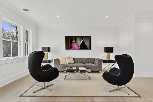 a living room with furniture a rug and a large window