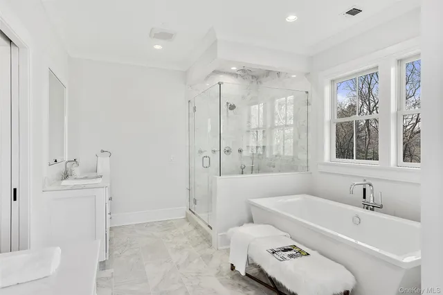 a bathroom with a tub sink toilet and mirror