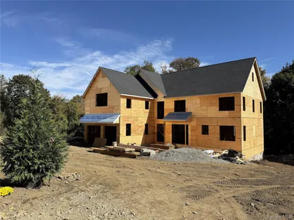 a view of a white house with a yard
