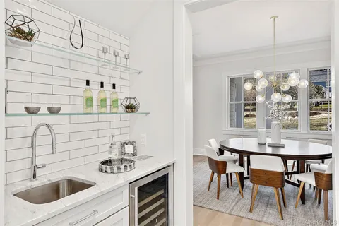 a kitchen with stainless steel appliances a sink a table and chairs