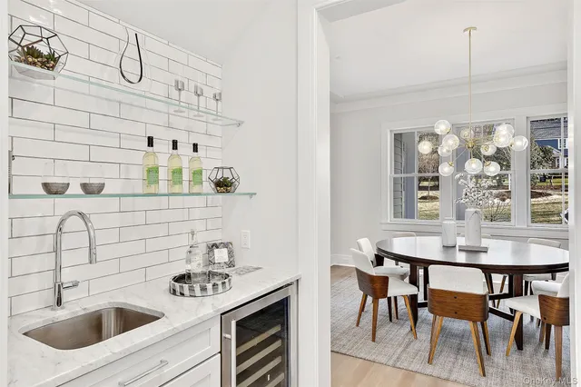 a kitchen with stainless steel appliances a sink a table and chairs