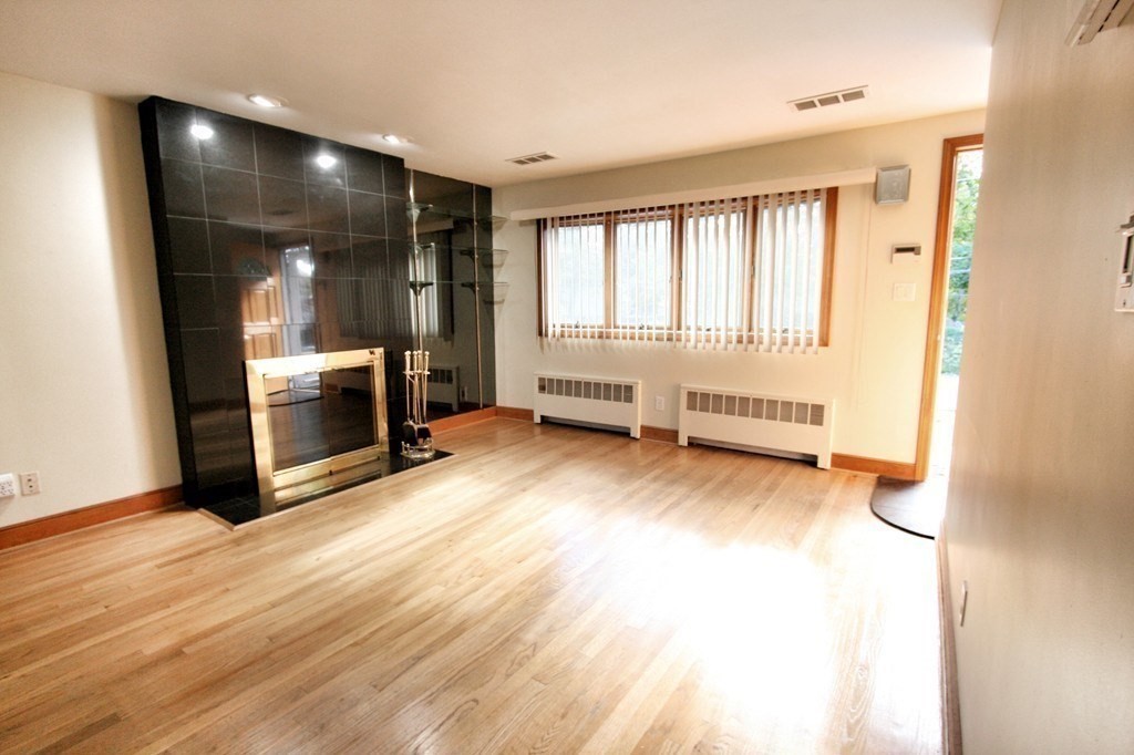 311 Ridge Street Arlington, MA 02474 - Photo 4 of 15 a view of livingroom with furniture and fireplace