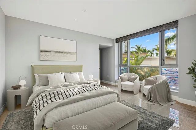 a bedroom with furniture and large windows