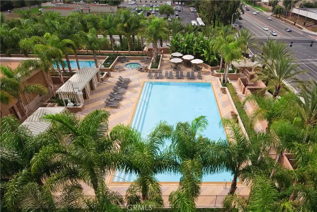 an aerial view of a house with swimming pool and lake view