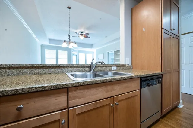 a kitchen with stainless steel appliances granite countertop a sink and a refrigerator