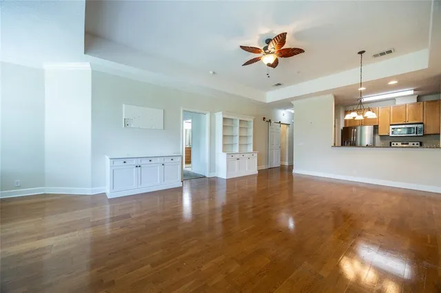a view of a kitchen with a sink hardwood floor and a ceiling fan