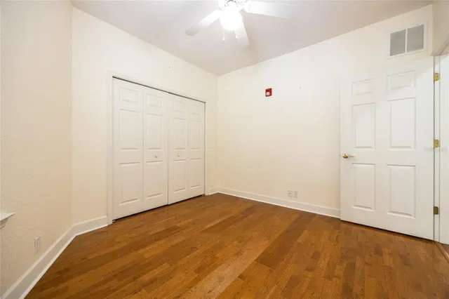 an empty room with a ceiling fan