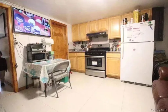 a kitchen with stainless steel appliances a stove a refrigerator and a refrigerator