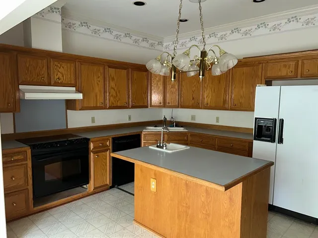 a kitchen with stainless steel appliances granite countertop a sink a stove and a microwave