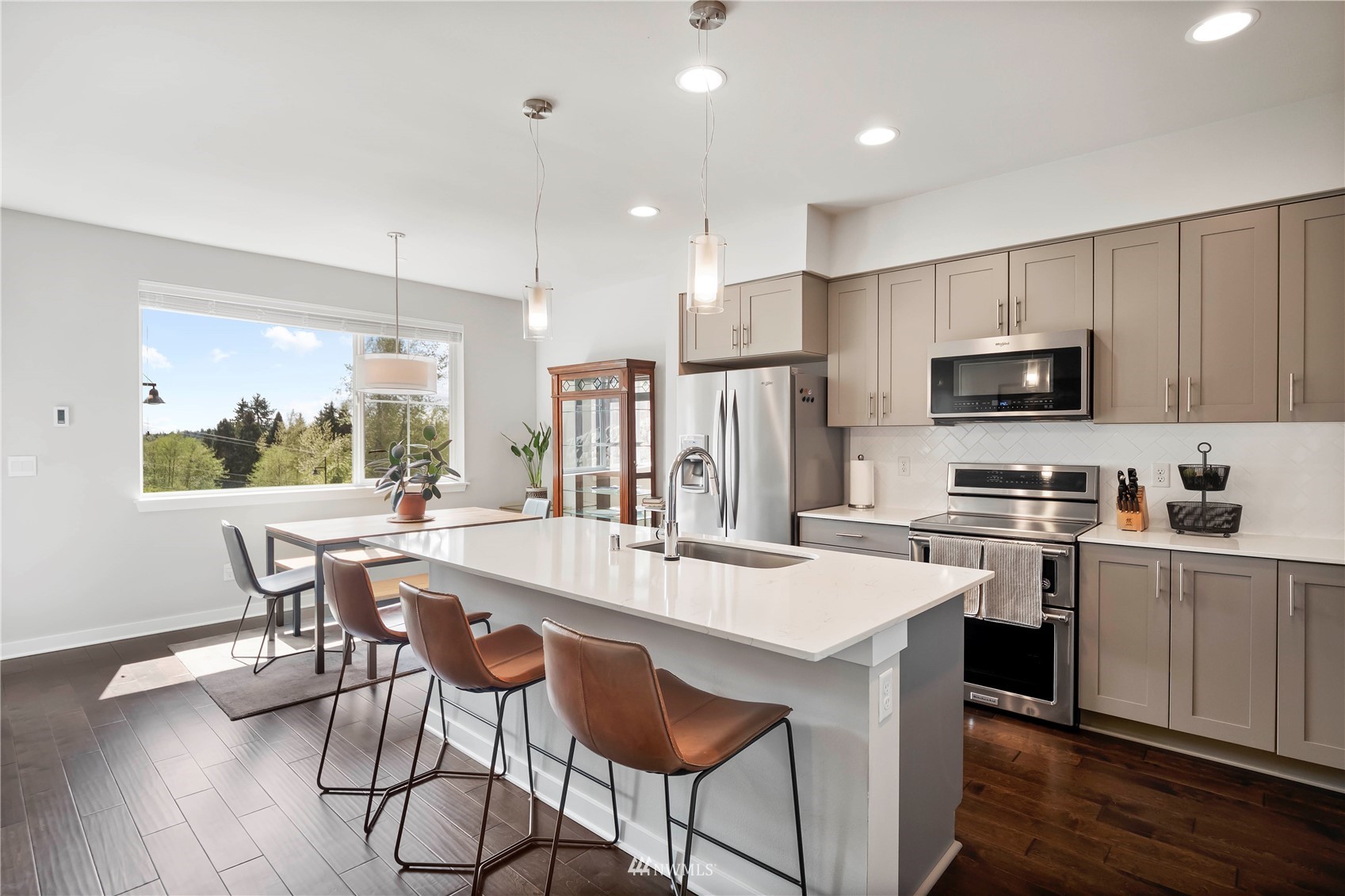 1325 Seattle Hill Road, Unit C4 Bothell, WA 98012 - Photo 6 of 33 a kitchen with stainless steel appliances granite countertop a stove a refrigerator a kitchen island with a dining table and chairs