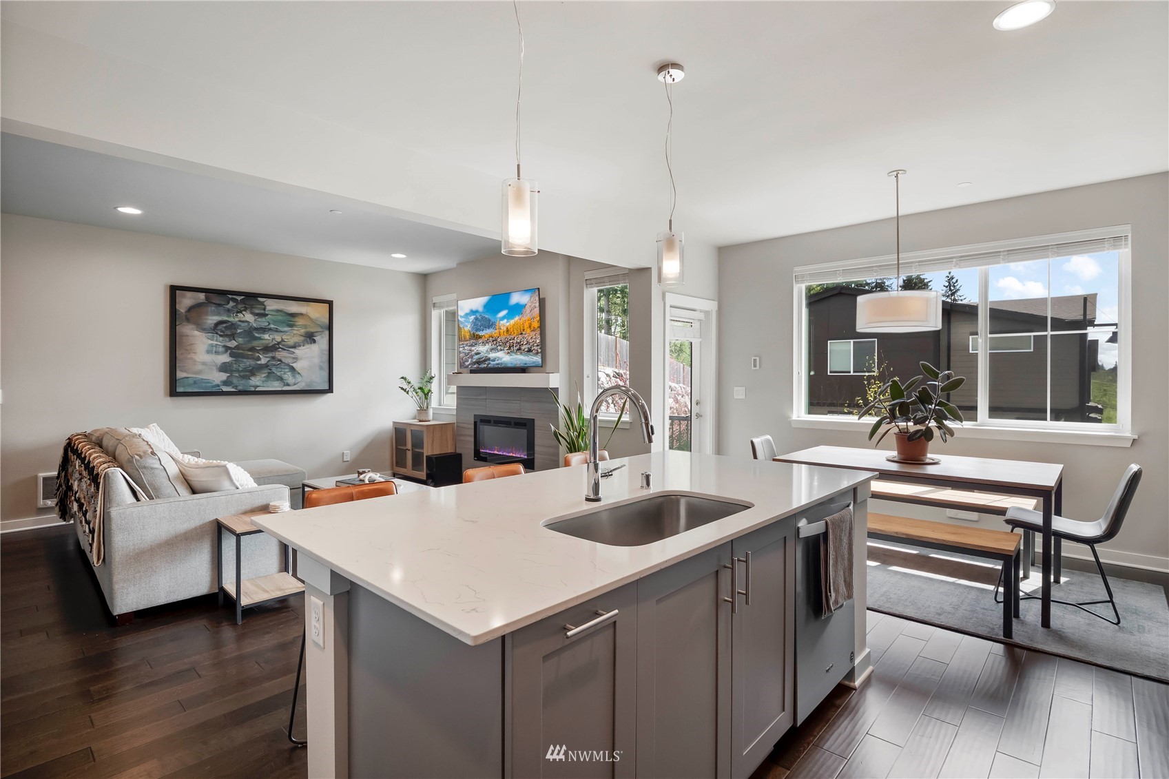 1325 Seattle Hill Road, Unit C4 Bothell, WA 98012 - Photo 7 of 33 a open kitchen with stainless steel appliances kitchen island granite countertop a sink and a fireplace