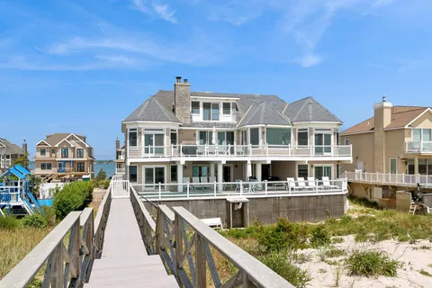 a view of a large building with a bench in front of house
