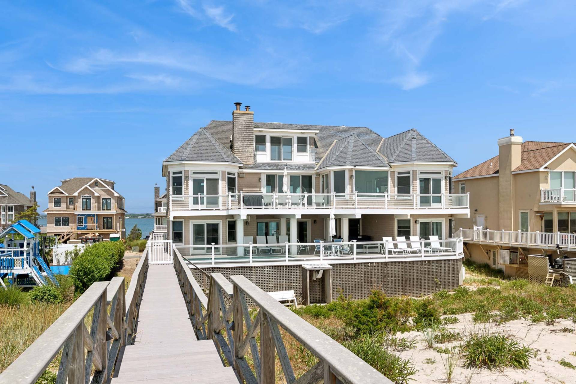 a view of a large building with a bench in front of house