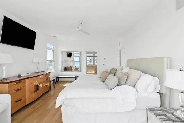 a bedroom with a large bed and a flat screen tv